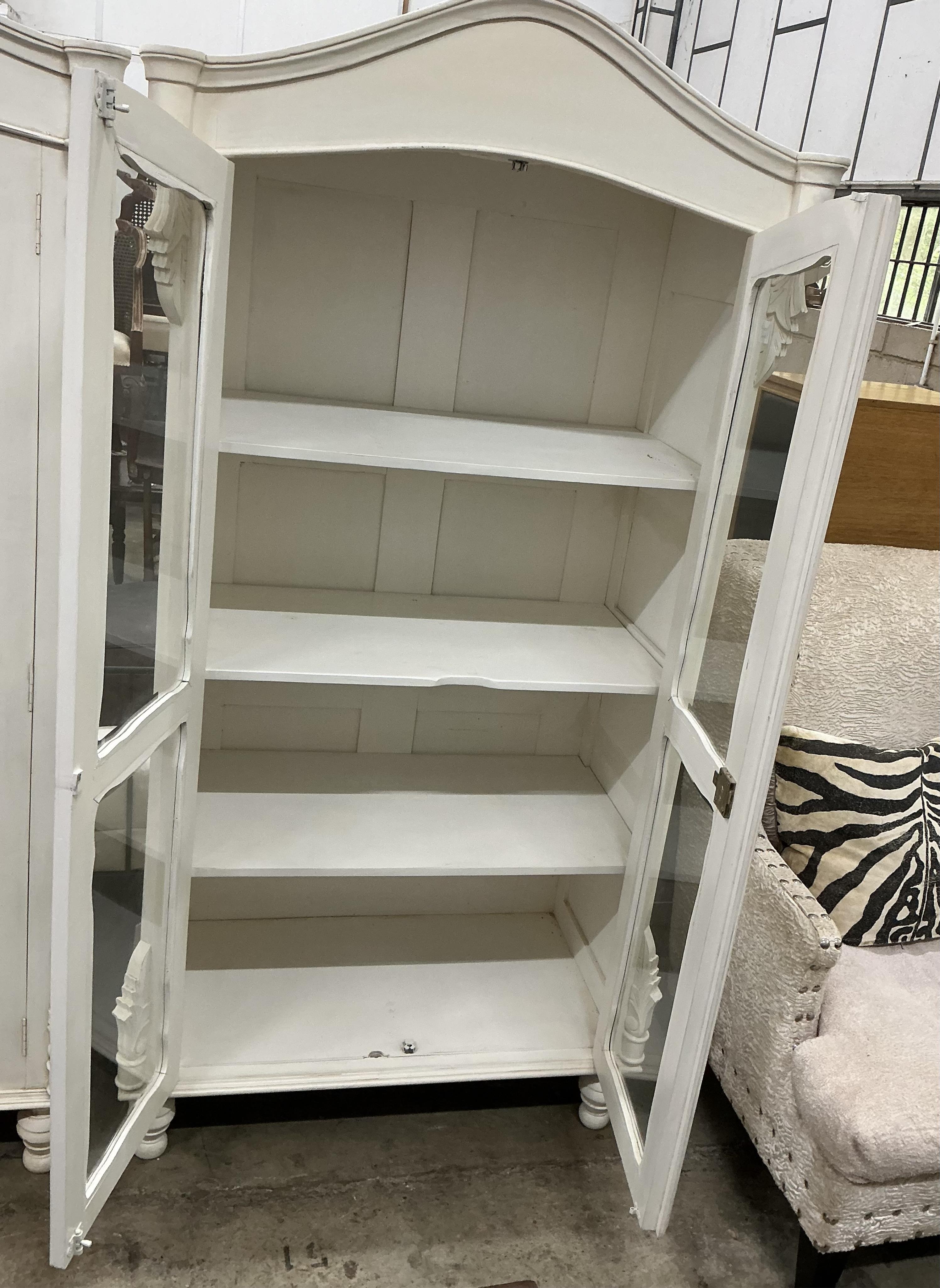 A pair of modern French Provincial style white painted two door glazed display cabinets, width 102cm, depth 54cm, height 185cm